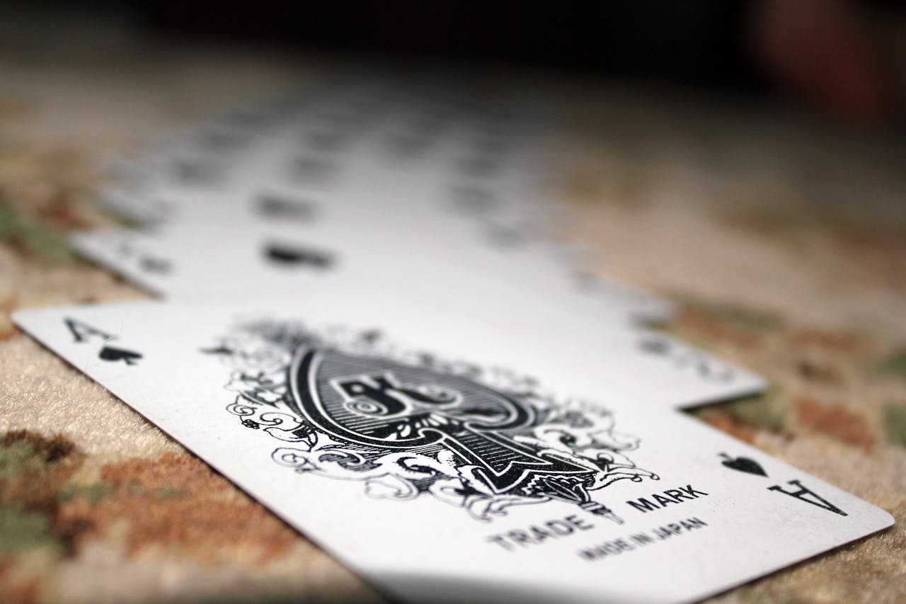 creative-02 Close-up of Ace of Spades with a deck of playing cards, showcasing depth of field.