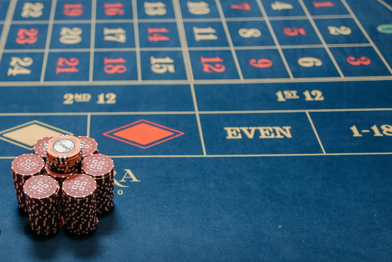 digital-01 Detailed image of a roulette table with poker chips stacked, showcasing casino gaming.